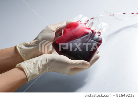Woman holding blood for transfusion on light background, closeup. Donation concept Woman holding blood for transfusion on light background, closeup. Donation concept 91649232