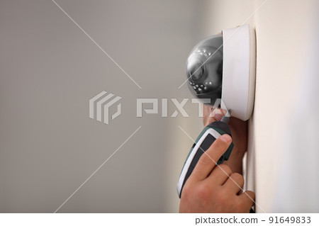 Technician installing CCTV camera on wall, closeup. Space for text Technician installing CCTV camera on wall, closeup. Space for text 91649833