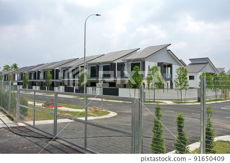 SELANGOR, MALAYSIA -MAY 2, 2022: Selected focused on new double story terrace house under construction in Malaysia. Construction progress is almost complete and almost ready to be occupied. 91650409