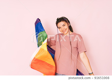 Girl with LGBT flag in front of a pink background 91651008