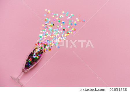 Transparent glass champagne goblet with confetti splash in form of multicolored Transparent glass champagne goblet with confetti splash in form of multicolored 91651288