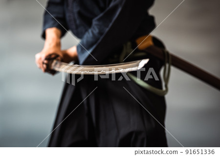 A person holding a Japanese sword A person holding a Japanese sword 91651336