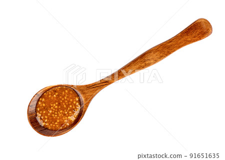 Top view of a wooden spoon with bavarian mustard on a white background. Top view of a wooden spoon with bavarian mustard on a white background. 91651635