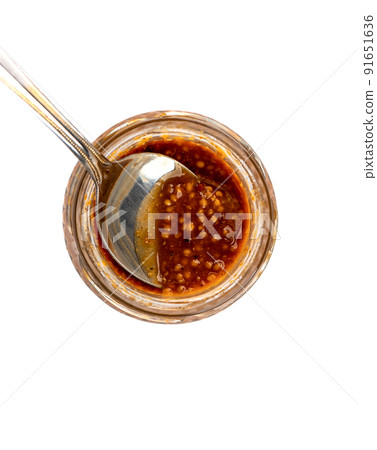Spoon inside a glass jar with Bavarian mustard. Spoon inside a glass jar with Bavarian mustard. 91651636