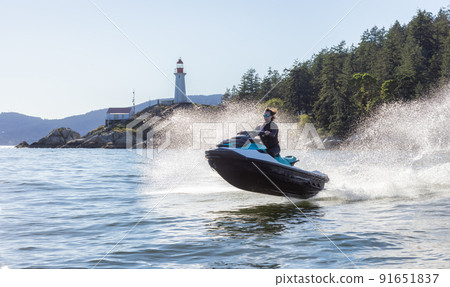 Adventurous Caucasian Woman on Sea-Doo riding in the Ocean Adventurous Caucasian Woman on Sea-Doo riding in the Ocean 91651837
