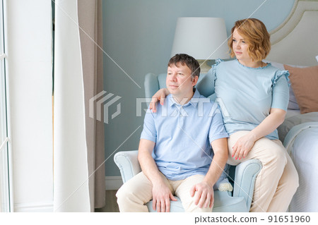 Serene couple man and woman enjoy being together. Sitting in same chair Serene couple man and woman enjoy being together. Sitting in same chair 91651960