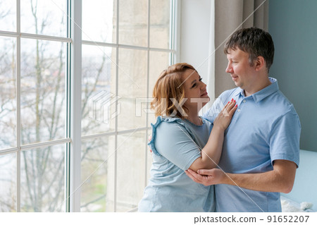 Happy time together. Smiling beautiful caucasian married couple in love hugging Happy time together. Smiling beautiful caucasian married couple in love hugging 91652207