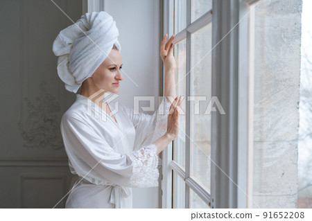 Portrait gorgeous young woman wearing white silk robe and turban towel on her Portrait gorgeous young woman wearing white silk robe and turban towel on her 91652208