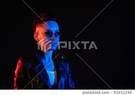 Night portrait of woman. Neon light. Positive attitude. Confident happy woman 91652248