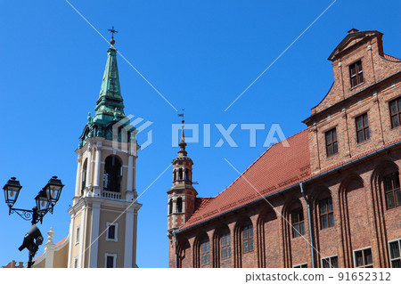 The Gothic Old Town Hall (Ratusz Staromiejski), Holy Spirit Church in Torun, Poland. August 2019 91652312