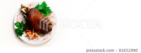 Roasted pork knuckle. Ham and bacon are popular foods in the west. Smoked ham hock with herbs and spices. White isolated background. Flat lay. German Haxe or Schweinshaxe. Banner 91652990