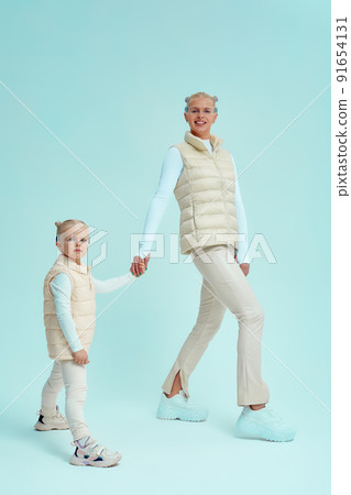 Young girl kid child with mother wearing smart glasses and explore alternative reality. Cyber space and virtual gaming. Discover future technology on blue background 91654131