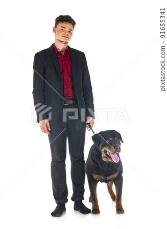 old rottweiler and owner in studio old rottweiler and owner in studio 91655341