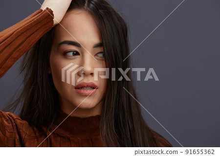 beautiful woman fun brown sweater posing casual wear emotions Gray background beautiful woman fun brown sweater posing casual wear emotions Gray background 91655362