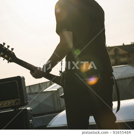 Guitarist playing outdoors. Guitarist playing outdoors. 91655484