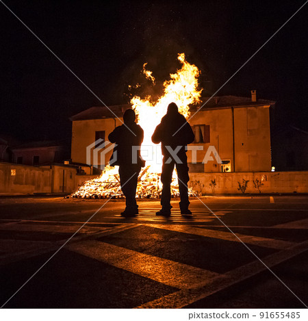 People in front at bonfire in a town People in front at bonfire in a town 91655485