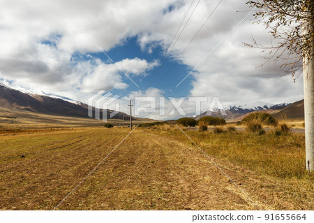 harvested agricultural field in a mountain valley in Kyrgyzstan 91655664