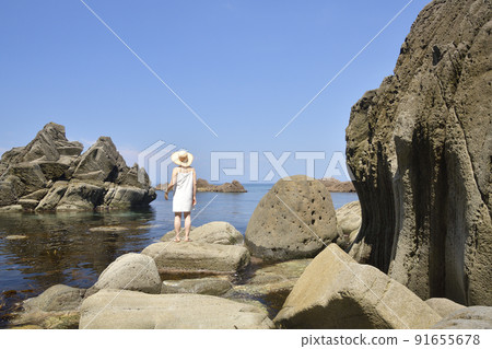 Taking a portrait of a woman on the coast of Setana Town, Hokkaido in the summer Taking a portrait of a woman on the coast of Setana Town, Hokkaido in the summer 91655678