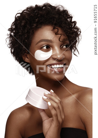 African American skincare models with perfect skin and curly hair with patches under her eyes . Beauty spa treatment concept. 91655715