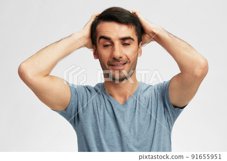handsome man in blue t-shirts gesture hands emotion cropped view 91655951