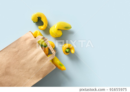 Abnormal ugly organic yellow pepper in paper bag. View from above. Abnormal ugly organic yellow pepper in paper bag. View from above. 91655975