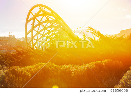 Tbilisi Bridge Of Peace At Twilight. Bridge Of Peace Is A Bow-shaped Pedestrian Bridge Over Kura River In Tbilisi, Capital Of Georgia, Linking Rike Park With Old Town In Central Tbilisi. Important Tbilisi Bridge Of Peace At Twilight. Bridge Of Peace Is A Bow-shaped Pedestrian Bridge Over Kura River In Tbilisi, Capital Of Georgia, Linking Rike Park With Old Town In Central Tbilisi. Important 91656006