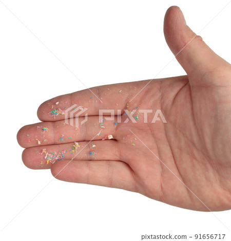 A microplastic on the hand, an exisolated background. The environmental problem with plastic 91656717