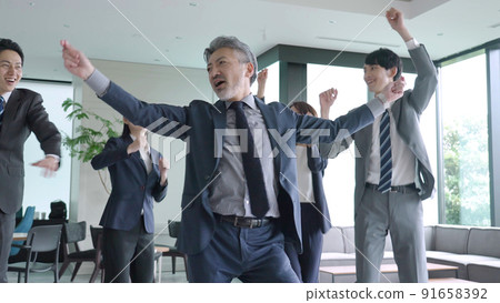 Business group dancing in the office Business group dancing in the office 91658392