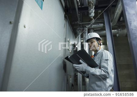 Male worker inspecting the factory Switchboard operation 91658586