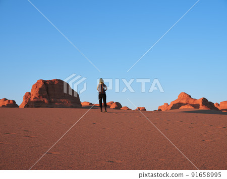 rear view of asian woman female tourist walking in national geological park near dunhuang, gansu province, china rear view of asian woman female tourist walking in national geological park near dunhuang, gansu province, china 91658995