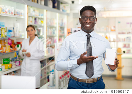 African american male chooses capsules for rubbing, restoring hair follicles on the head 91660147