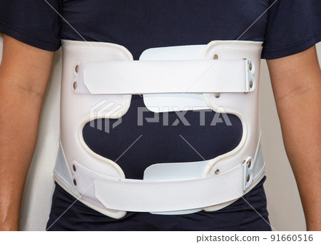 A person wearing a lumbar corset A person wearing a lumbar corset 91660516