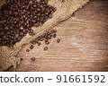Fresh coffee beans on canvas texture background 91661592
