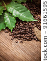 Fresh coffee beans on canvas texture background 91661595