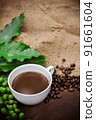 Cup coffee and beans on wood background 91661604