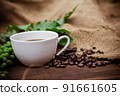 Cup coffee and beans on wood background 91661605