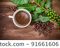 Cup coffee and beans on wood background 91661606