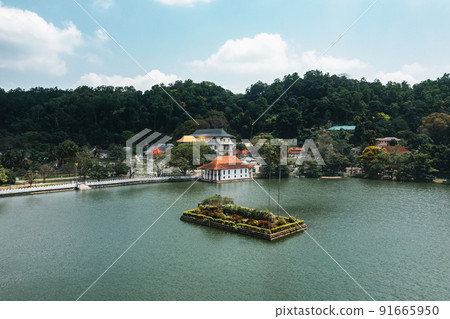 Aerial drone view of Kandy lake and famous city landmark Sri Dalada Maligawa Temple in Sri Lanka. Aerial drone view of Kandy lake and famous city landmark Sri Dalada Maligawa Temple in Sri Lanka. 91665950
