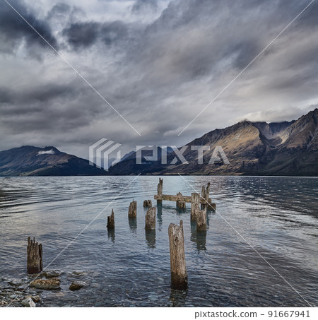 Mountain lake with old ruined pier 91667941