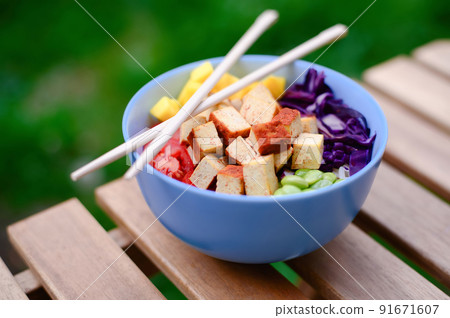 Tofu vegetarian poke bowl on wooden table Tofu vegetarian poke bowl on wooden table 91671607