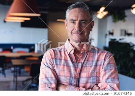Portrait of confident mature caucasian businessman in creative office Portrait of confident mature caucasian businessman in creative office 91674346