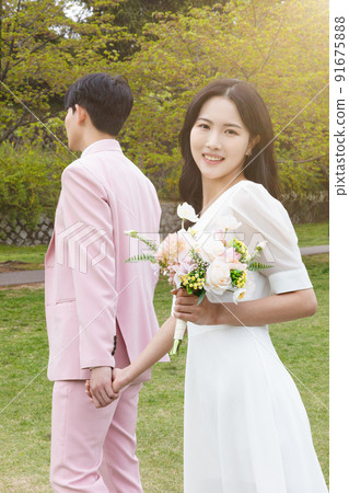 Korean Asian couple self small wedding concept in spring, talking a walk 91675888
