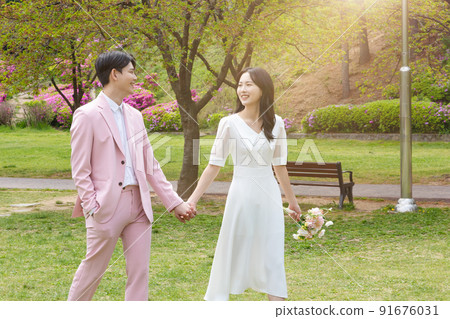 Korean Asian couple self small wedding concept in spring, talking a walk 91676031
