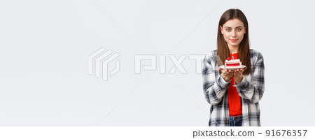 People lifestyle, holidays and celebration, emotions concept. Dreamy gorgeous young woman celebrate her birthday, holding b-day cake with lit candle, smiling kind at camera People lifestyle, holidays and celebration, emotions concept. Dreamy gorgeous young woman celebrate her birthday, holding b-day cake with lit candle, smiling kind at camera 91676357