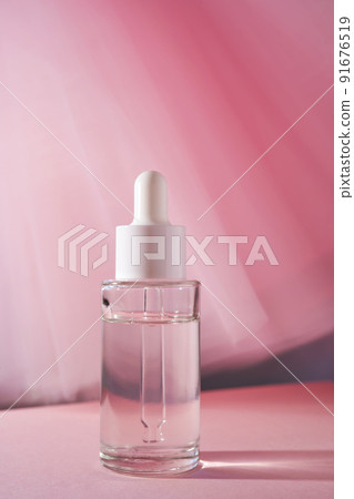 Transparent bottle of cosmetic gel on a pink background. Transparent bottle of cosmetic gel on a pink background. 91676519