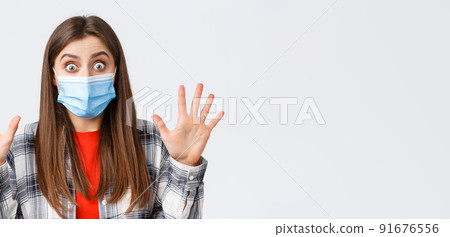 Coronavirus outbreak, leisure on quarantine, social distancing and emotions concept. Excited young attractive woman in medical mask show ten fingers, number or amount, stare impressed Coronavirus outbreak, leisure on quarantine, social distancing and emotions concept. Excited young attractive woman in medical mask show ten fingers, number or amount, stare impressed 91676556