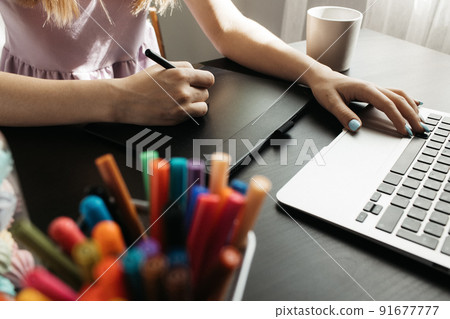 Close up of female graphic designer drawing sketches on graphic tablet 91677777