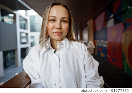 Beautiful young blonde businesswoman in urban background 91677873