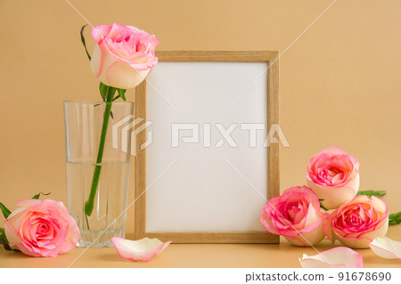 Mockup Wooden frame with Empty white paper blank and delicate pink roses on beige background. Minimal trendy composition. Romantic pastel pink rose flowers. Neutral earth tones. Copy space Mockup Wooden frame with Empty white paper blank and delicate pink roses on beige background. Minimal trendy composition. Romantic pastel pink rose flowers. Neutral earth tones. Copy space 91678690