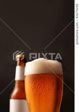 Bottle and glass of beer on black background. 91679266